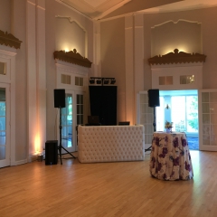 White tufted DJ booth Champagne LED uplights