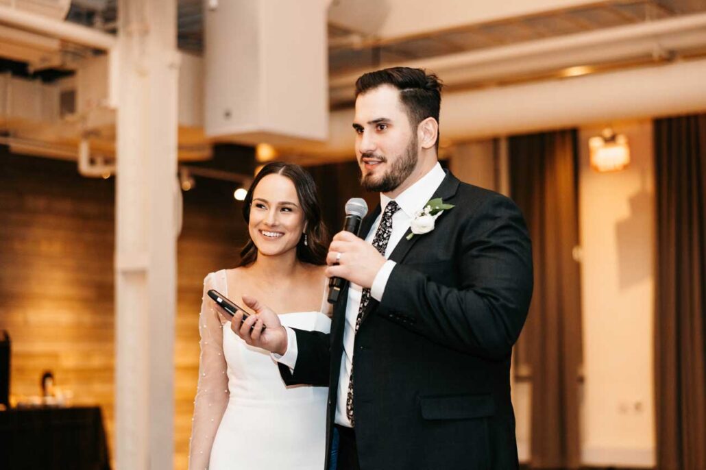 Photo well lit wedding couple giving speach hero